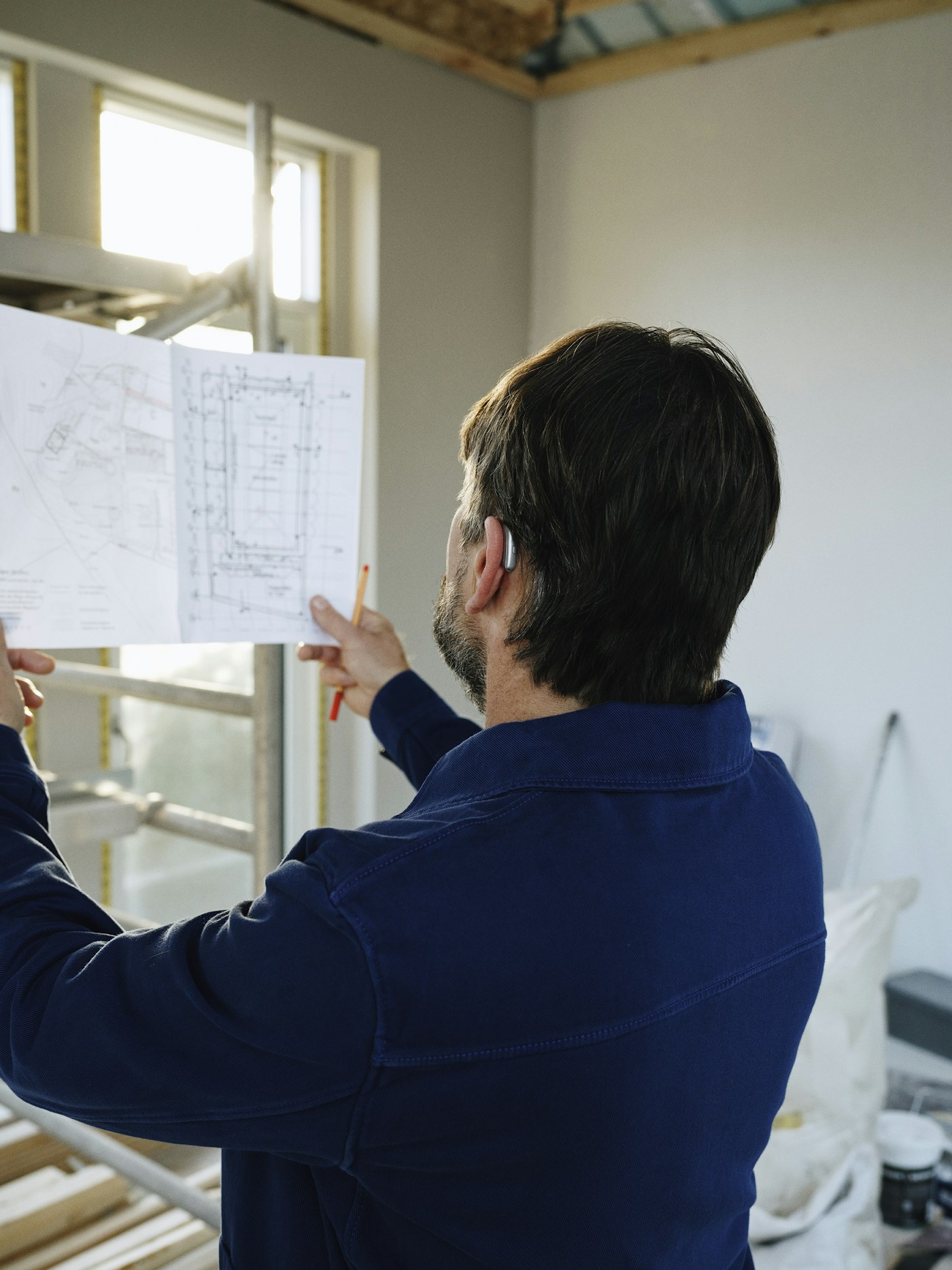 Reviewing building plans on a residential job site